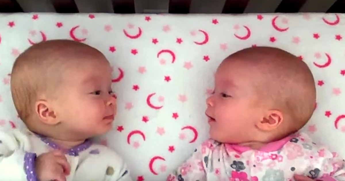 identical-twin-girls-talk-to-each-other-featured